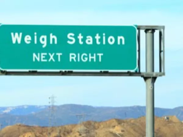 Road sign reading "weigh station next right."