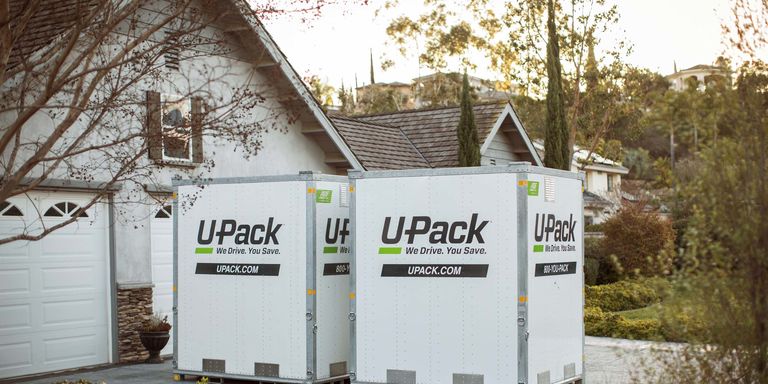 Two U-Pack ReloCubes sitting in a residential driveway
