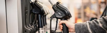 Hand picking up gas pump