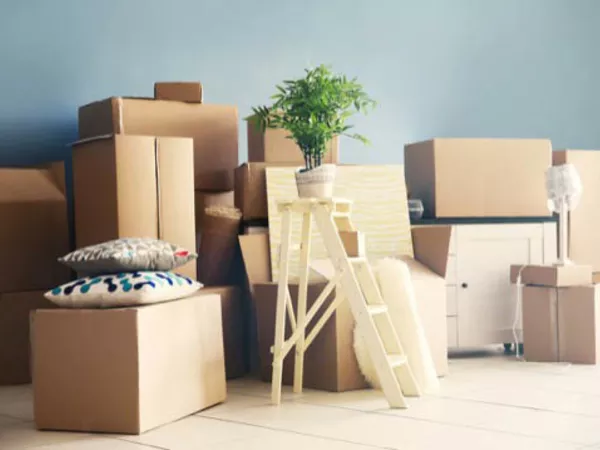 Stacks of boxes, furniture and other items on the floor prepared for an apartment move