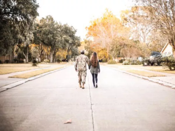 Army man walking with wife after making an Army DITY move.
