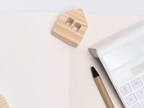 Calculator, pen and paper to calculate the cost to rent a moving truck.