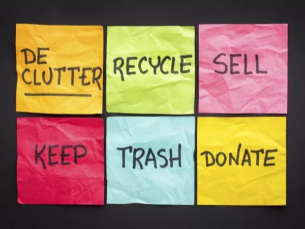 Woman decluttering a linen closet before moving.
