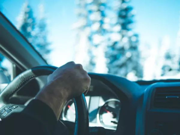 Person driving in snow and ice.