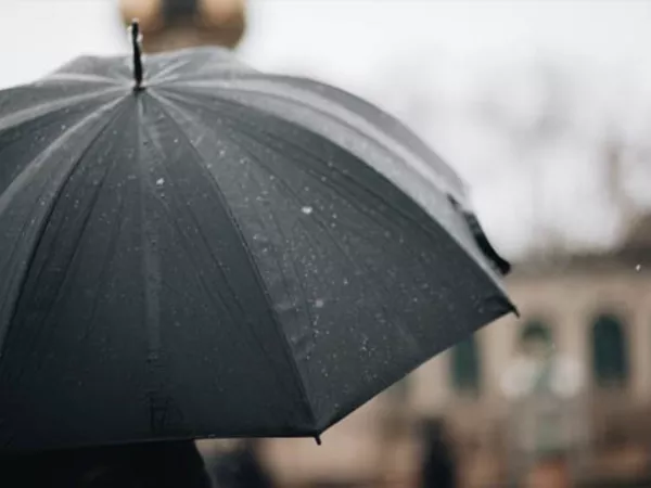 Black umbrella used to protect items when moving in the rain.