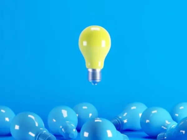 Sea of blue lightbulbs with one yellow bulb floating above, showing the thought of Penske truck rentals.