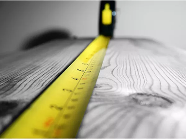 Tape measure measuring linear footage.