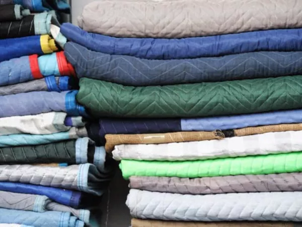 stack of moving blankets folded and ready to use for wrapping furniture