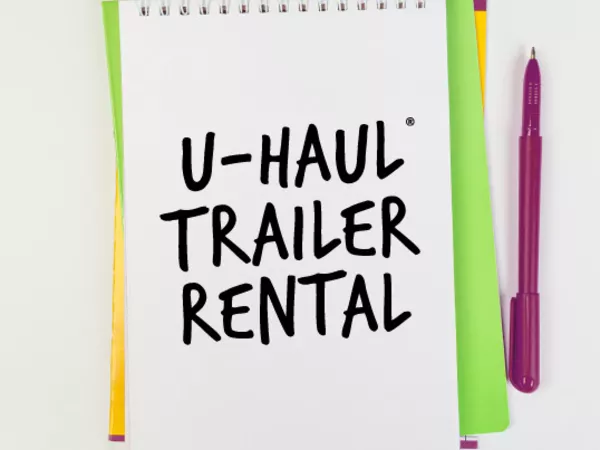 Notepad with text reading &quot;U-Haul Trailer Rental&quot;
