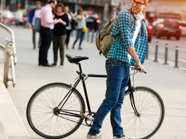 Man wheels bike getting ready to pack it for moving.