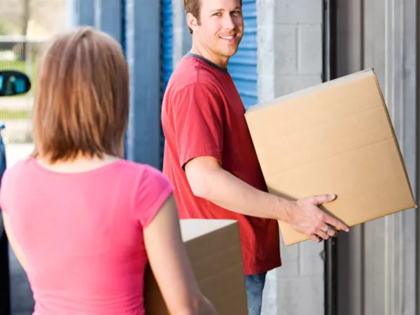 Couple moving boxes out of a storage unit for their move