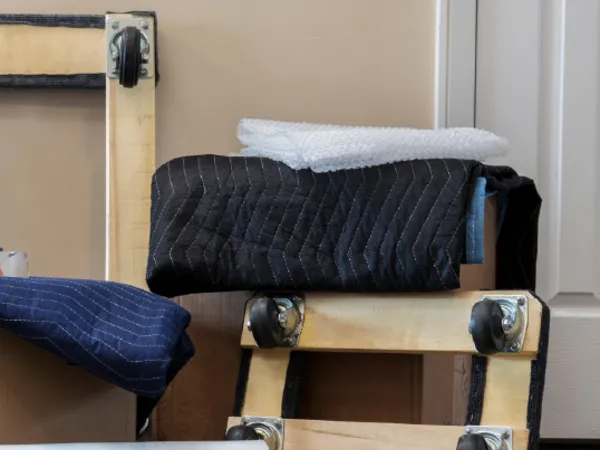 Furniture dollies, moving blankets and plastic stretch wrap are essential supplies for moving day.
