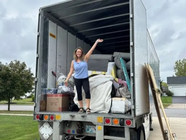Woman standing in a U-Pack moving trailer with linear footage lines showing clearly on trailer walls.