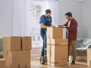 Man looking at paperwork from moving crew to determine the cross country moving costs.