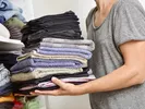 woman decluttering linen closet