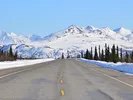 View of open road and Alaskan mountains which you would see when driving to Alaska.