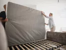 Couple moving a mattress.