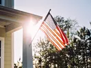 Ameircan flag on front porch post, symbolizing moving discounts for military members.