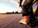 Person driving a motorcycle during a long distance move.