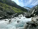 Image of Alaskan river with the mountains and blue sky, a view seen after moving to Alaska.