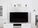 Large screen TV in a living room, waiting to be packed before a move.