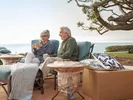 Senior couple relaxing outside after their coast-to-coast move.