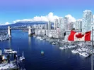 View of bridge showing the move from U.S. to Canada and a Canadian flag flying in the foreground.