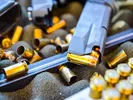 Image of firearms being unloaded and ammo sitting ready to be shipped.
