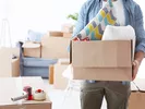 Person safely lifting a moving box.