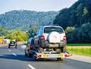 car being towed on a car trailer during a move