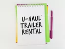Notepad reading "U-Haul Trailer Rental"