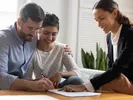 Couple signs apartment lease while landlord explains how to get their deposit back after moving.