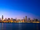 Image of Downtown Chicago, Illinois skyline across Lake Michigan at sunset.