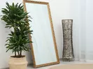 Large mirror propped against a wall.