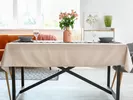 Decorating a dining room on a budget with an elegant centerpiece and tablecloth.