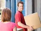 Couple moving boxes out of a storage unit for their move