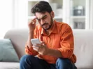 A man reviewing a U-Pack pricing change on his phone.